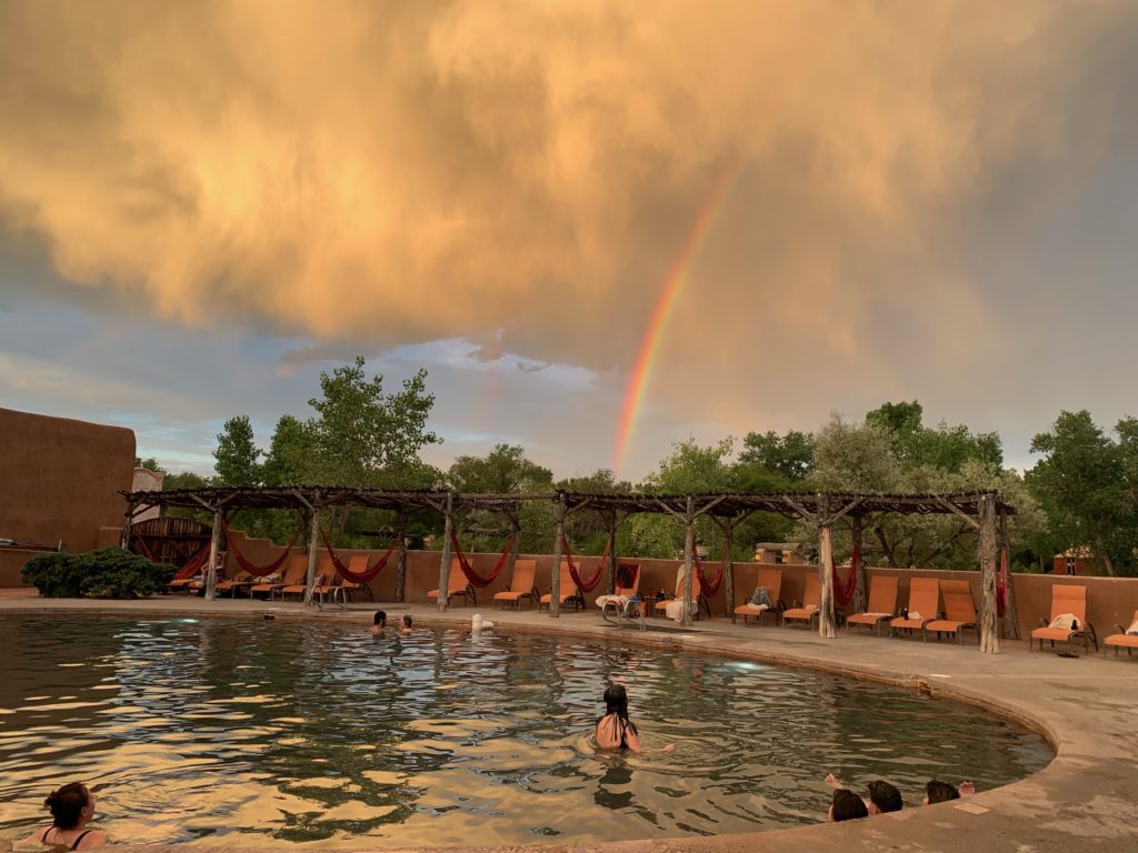 Legendary Healing Waters of Ojo Caliente soaking pool with rainbow
